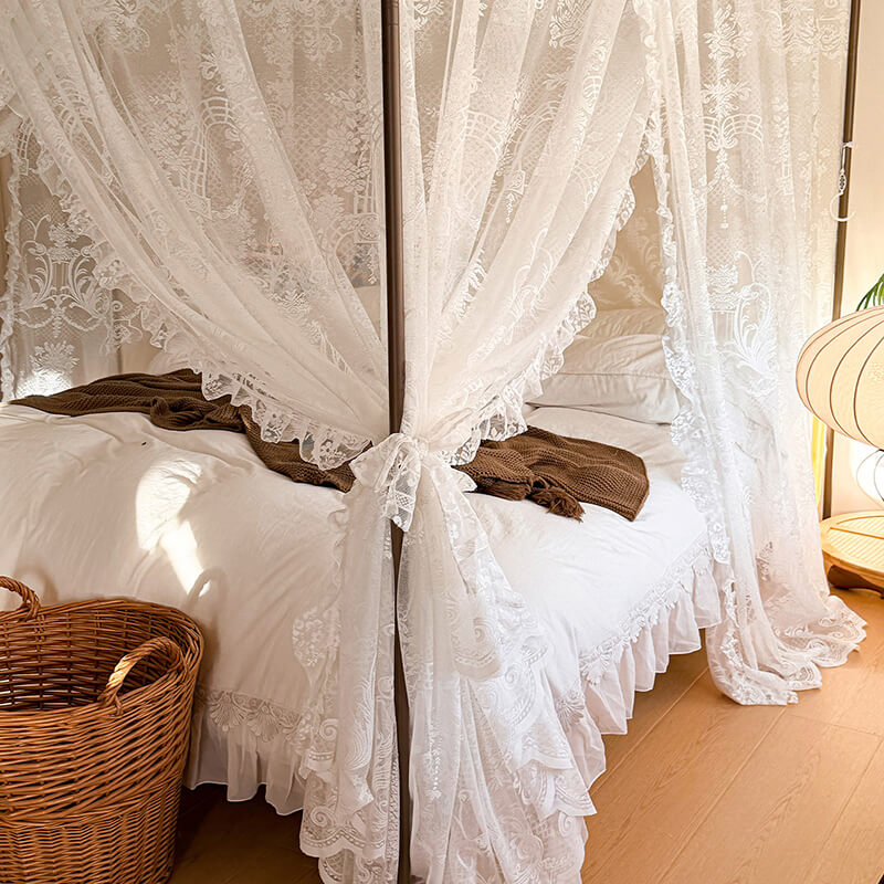 Bed with lace curtains and a wicker basket in a bedroom setting