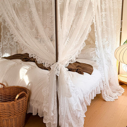 Bed with lace curtains and a wicker basket in a bedroom setting