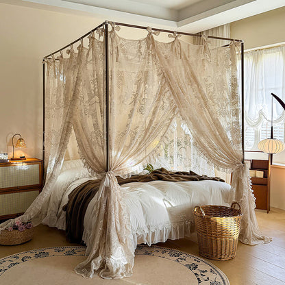 Bedroom with a canopy bed featuring lace curtains and decorative elements.