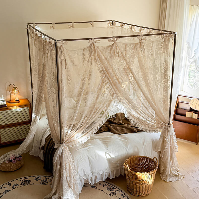 Four-poster bed with lace curtains in a bedroom setting
