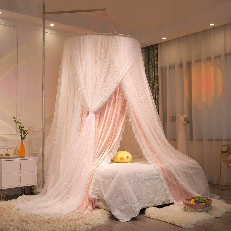 Elegant pink canopy for a twin bed, featuring a double layer of printed fabric and sheer netting, creating a decorative and cozy princess bedroom atmosphere.