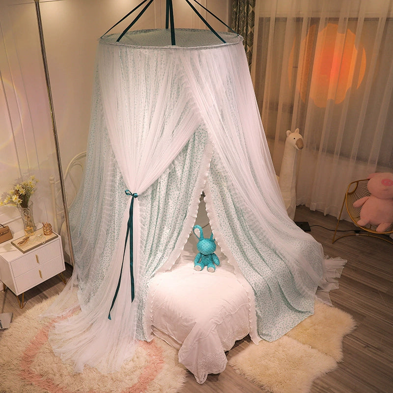 Blue-green princess canopy for bed hung over a small white child's chair or pouf, creating a draped reading or rest corner in a bedroom setting.