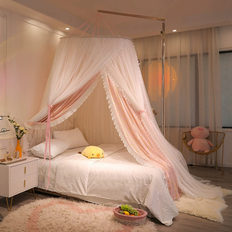 Hanging bed canopy with pink floral liner and white sheer overlay, mounted on a side frame and gracefully draping over a twin-size bed in a girl's bedroom