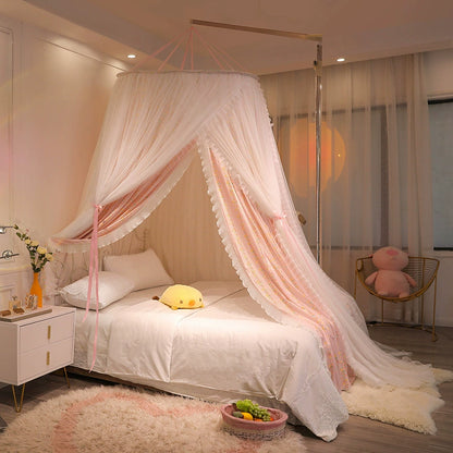 Hanging bed canopy with pink floral liner and white sheer overlay, mounted on a side frame and gracefully draping over a twin-size bed in a girl's bedroom