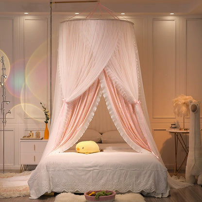 Luxurious kids bed canopy with pink fabric and white tulle, tied open and centered over a queen-size bed with white bedding, adding a touch of fairytale decor.