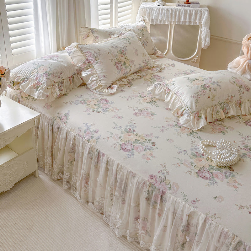 Floral bed skirt on a bed in a softly lit room