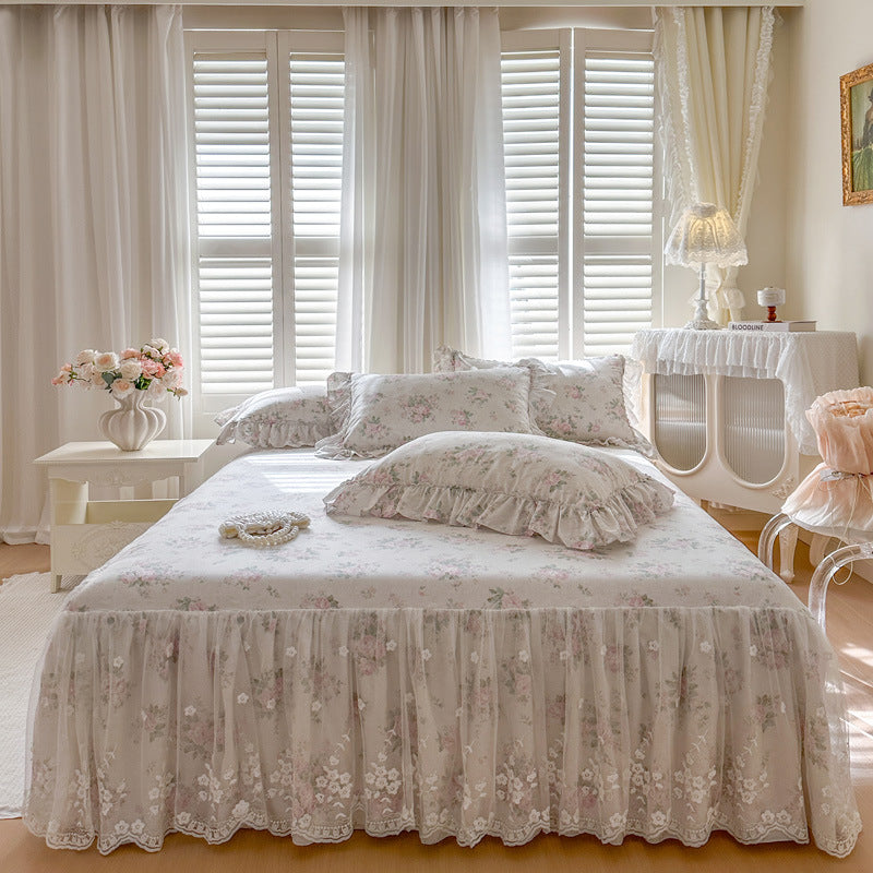 Neatly made bed with floral bedding in a bright bedroom