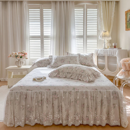 Neatly made bed with floral bedding in a bright bedroom