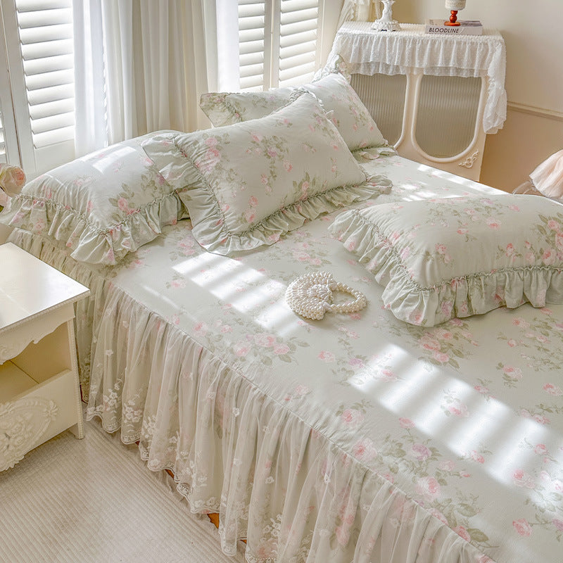Sage Rose Garden bed skirt with ruffles on a bed in a bright bedroom.