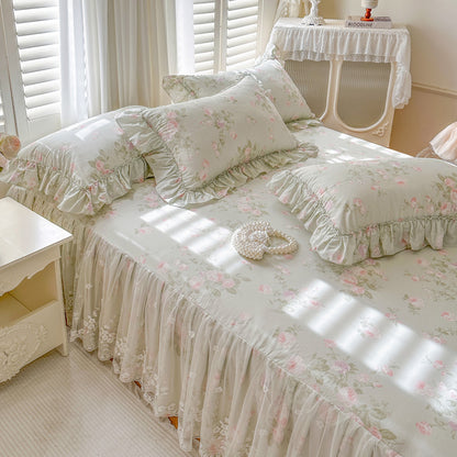 Sage Rose Garden bed skirt with ruffles on a bed in a bright bedroom.
