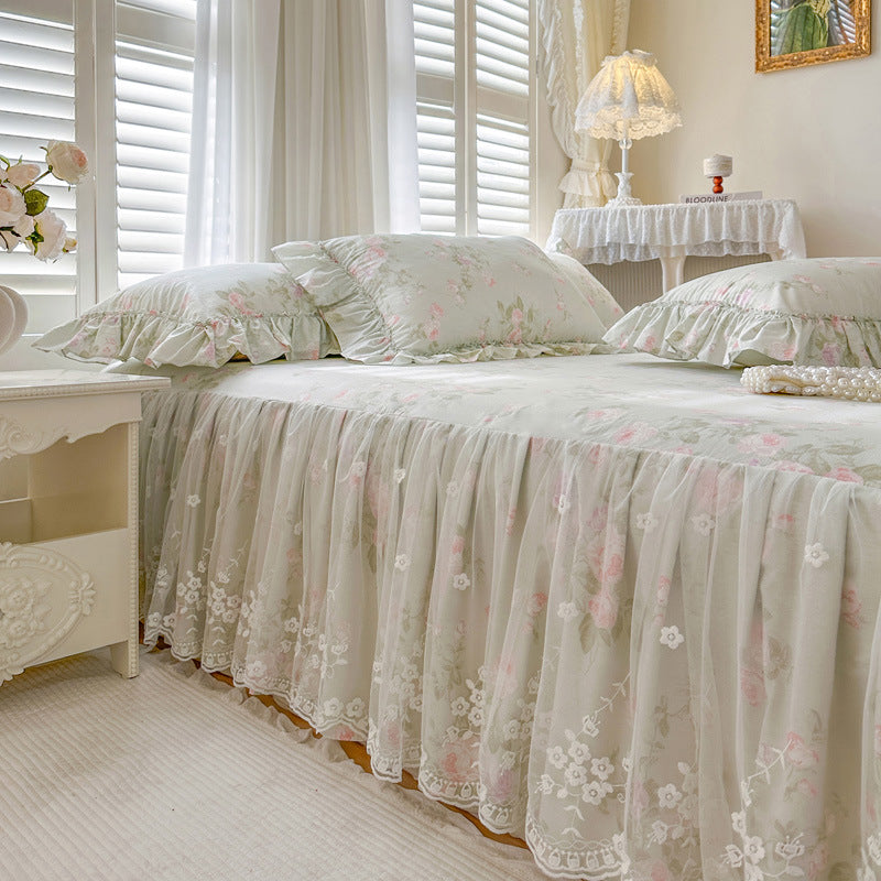 Bedroom with Sage Rose Garden floral bedding and white furniture
