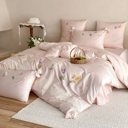 Blush pink floral embroidered bedding set with raised flower details, lace trim, and soft romantic teen bedroom styling