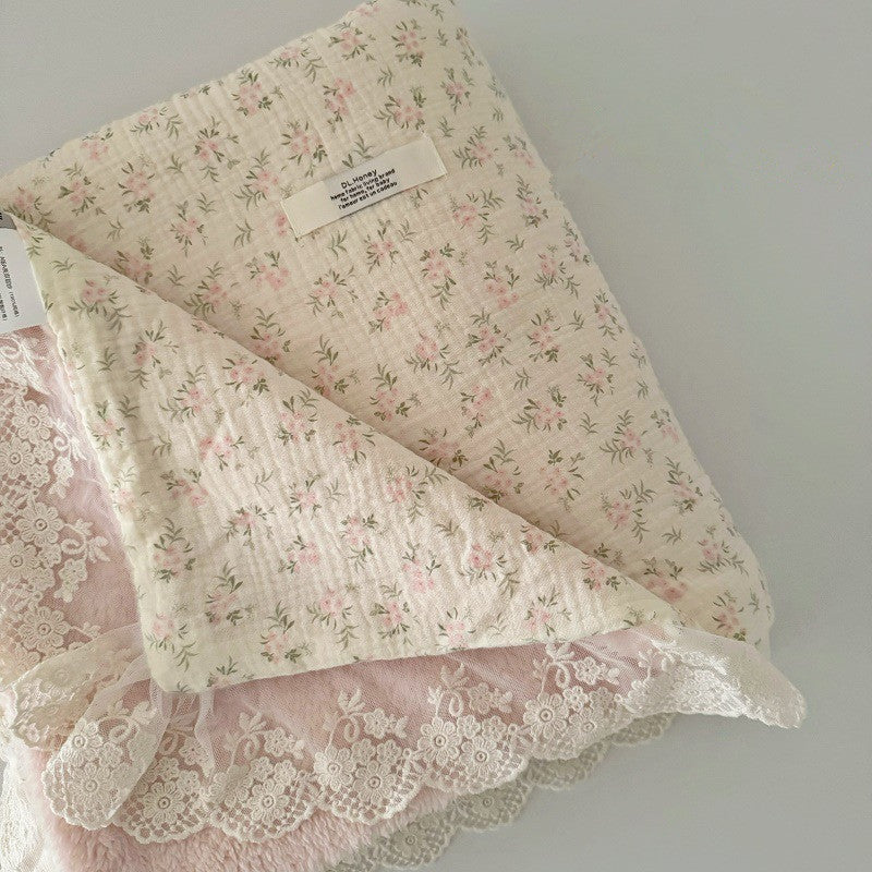 Cotton gauze nursery bedding featuring pink rose cluster print, textured fabric detail, and vintage-style lace border.