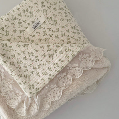 Soft floral ruffle comforter with green leafy twig print on crinkled cotton gauze, lined with warm plush fleece.