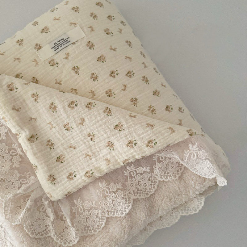 Vintage brown floral print muslin comforter folded, highlighting breathable gauze fabric and warm fleece backing.