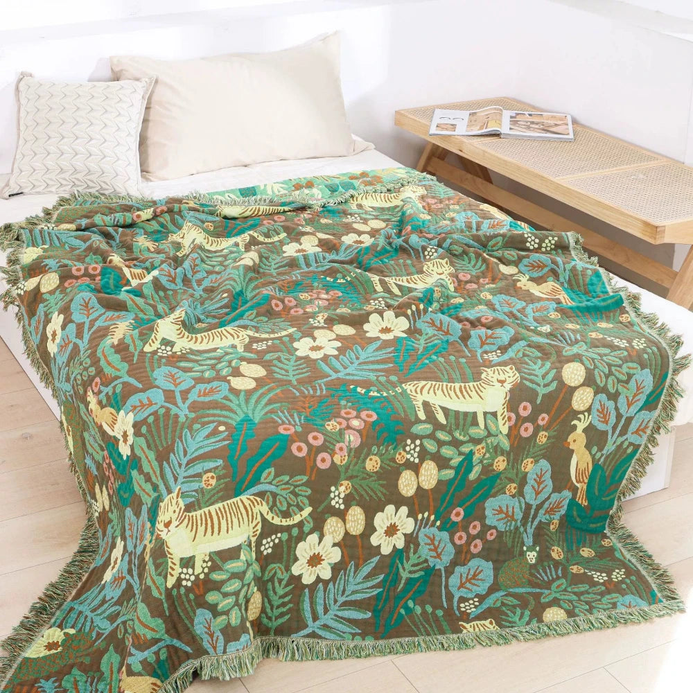 Jungle animal cotton jacquard throw blanket styled on a bed
