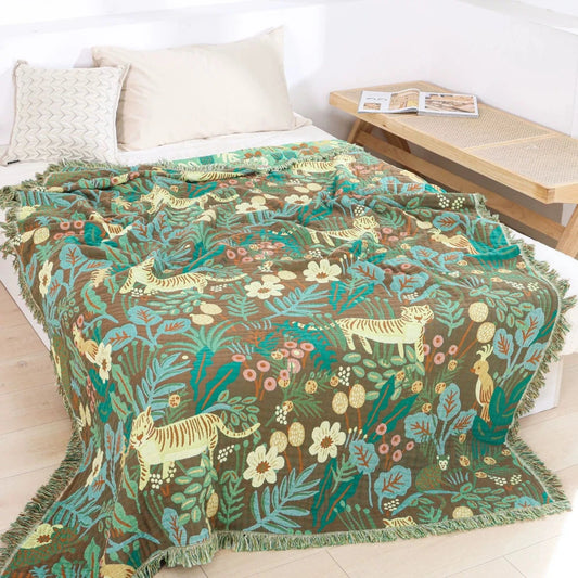 Jungle animal cotton jacquard throw blanket styled on a bed