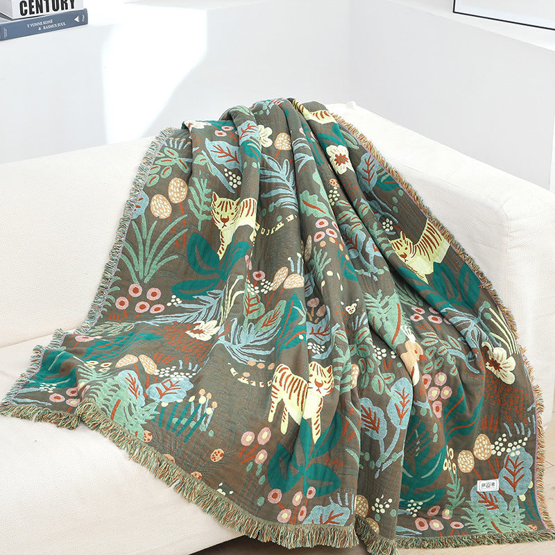 Cotton jacquard jungle throw blanket draped over a sofa