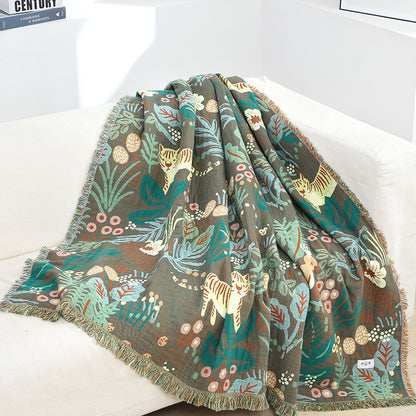 Cotton jacquard jungle throw blanket draped over a sofa