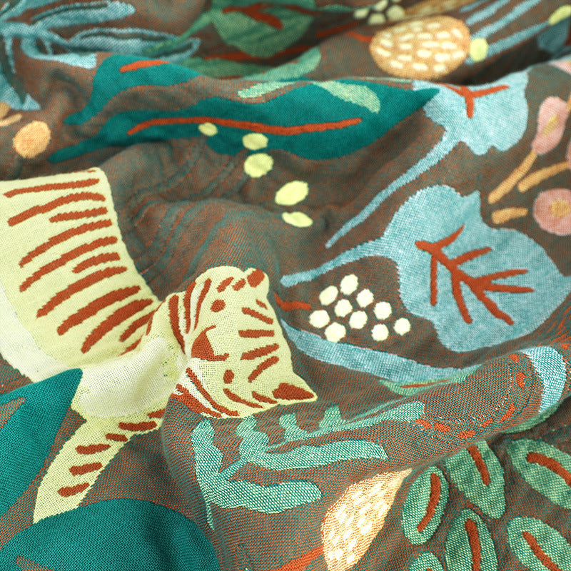 Tiger and botanical woven detail on cotton jacquard blanket