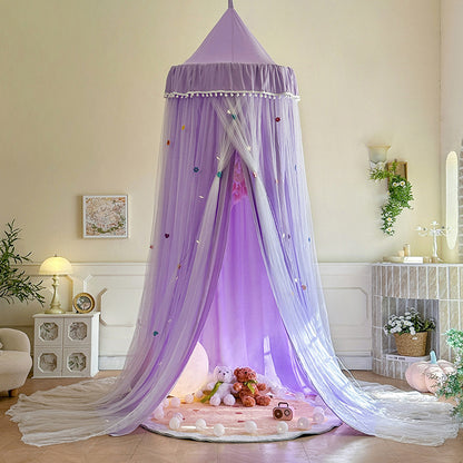 Lavender Purple double-layer kids canopy tent with pom-pom trim, set up as a dreamy play area over a round rug with a moon lamp and stuffed animals inside.