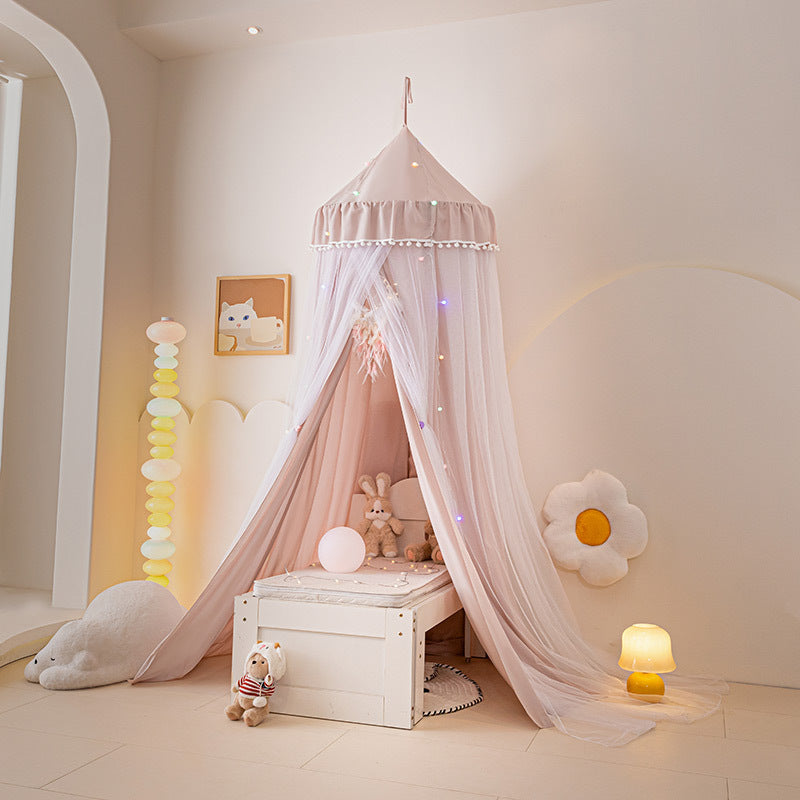 Pale Pink double-layer bed canopy tent with white pom-pom fringe, hung over a small white wooden bench/bed, ideal for a sweet girls' room or play tent decor.