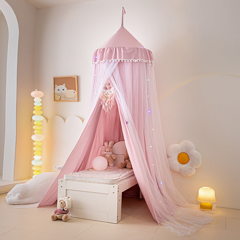 Dusty Pink floor-length bed canopy tent with white pom-pom trim, creating a charming and safe sleeping or play area over a small bed, emphasizing the rich color tone.