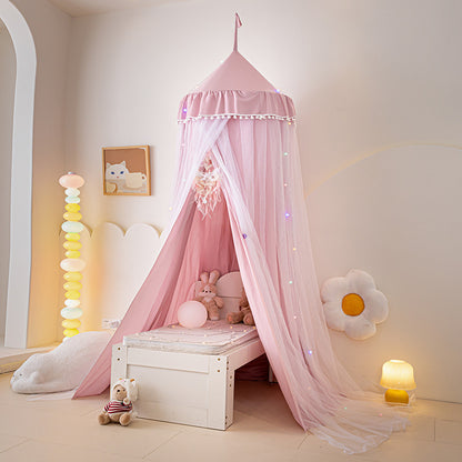 Dusty Pink floor-length bed canopy tent with white pom-pom trim, creating a charming and safe sleeping or play area over a small bed, emphasizing the rich color tone.