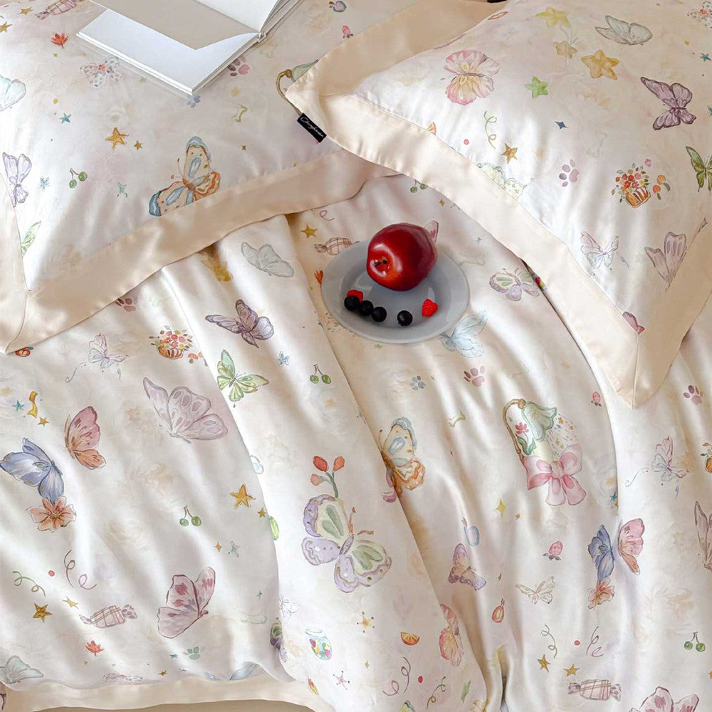 Macro view of the champagne butterfly bedding set highlighting the brand label on the pillowcase and the intricate, high-quality watercolor print on the eco-friendly Lyocell fabric.