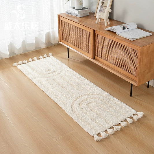Minimalist rainbow handmade cotton tassel runner rug in ivory color, styled in a minimalist home decor setting.