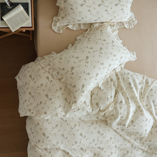 Moon Balloon Duvet Cover Set in ruffled cotton muslin with ivory celestial print and cozy book styling