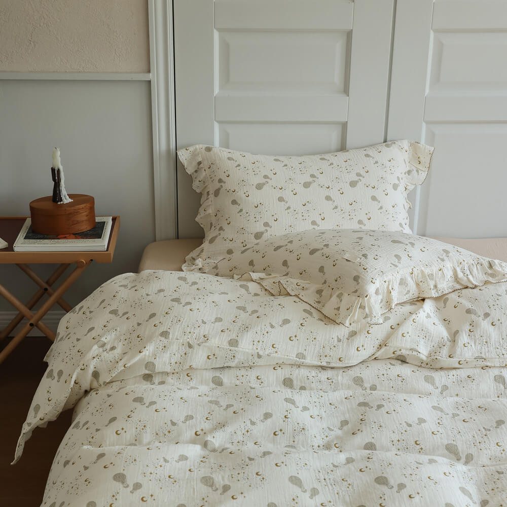 Moon Balloon bedding styled in a cozy teen bedroom with warm ivory tones and soft ruffled details
