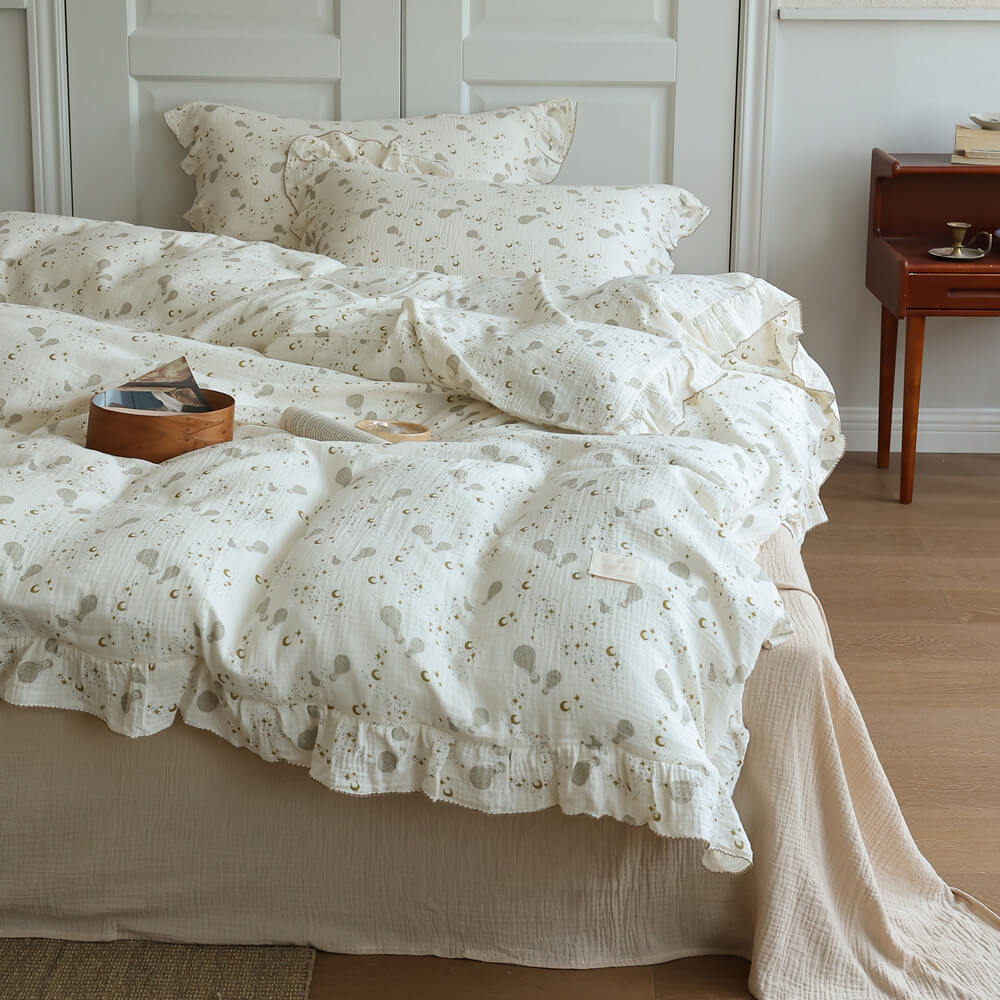 Moon Balloon duvet cover and pillowcases shown with matching ruffled cotton muslin details