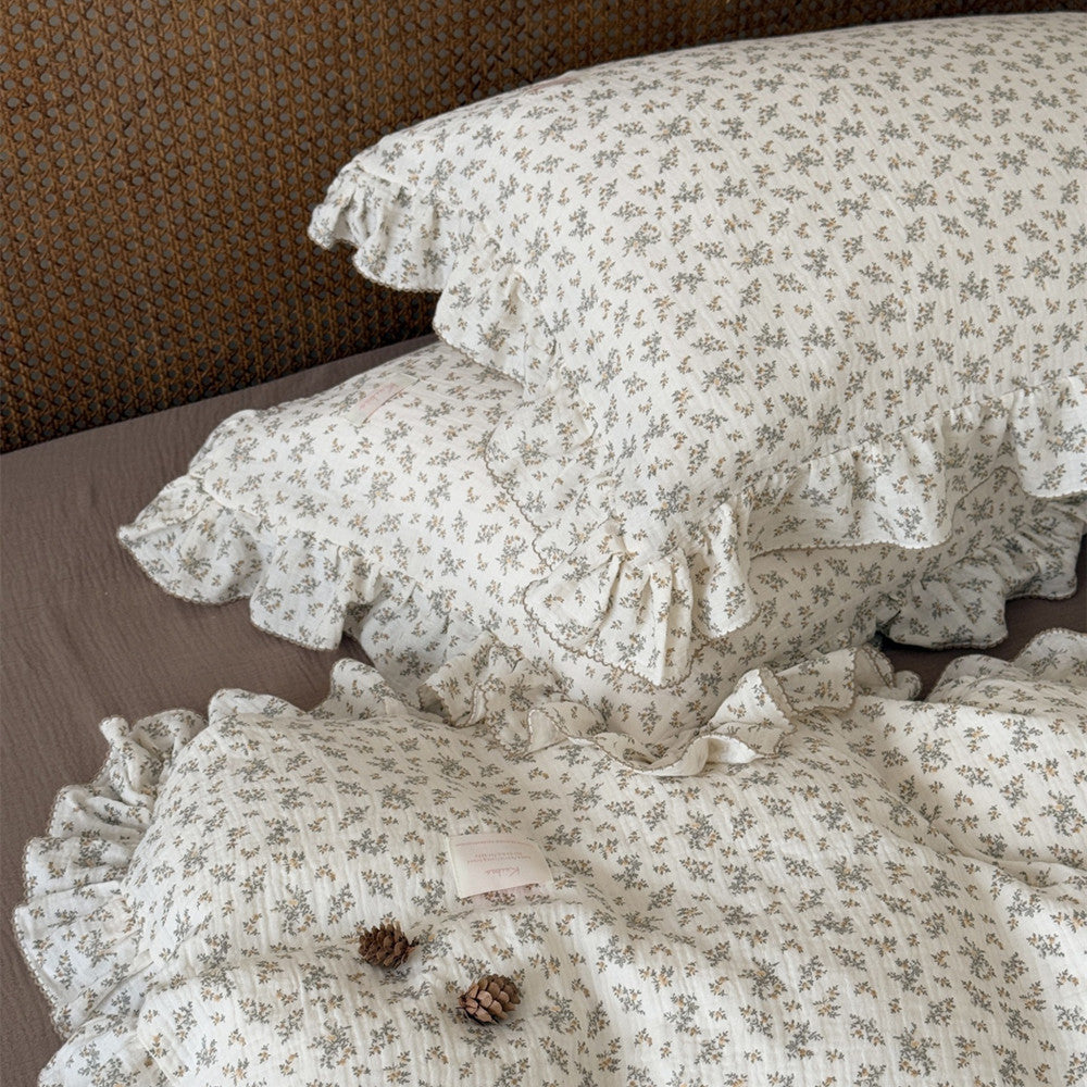 Two ruffled pillowcases with osmanthus floral print, showcasing the soft cotton gauze material and delicate print details