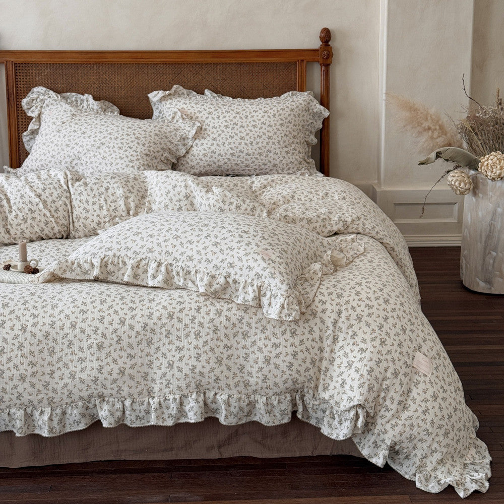 A full view of the osmanthus floral print bedding set, including the duvet cover, pillowcases, and flat sheet, on a wooden bed frame, creating a romantic and elegant bedroom atmosphere