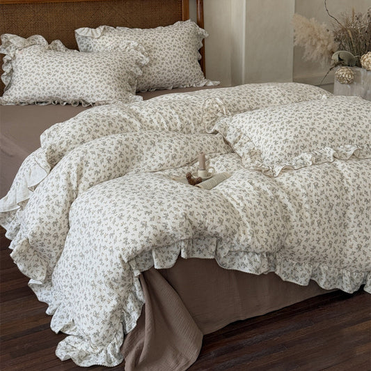 An aerial view of the bedding set, showcasing the cohesive look of the duvet cover, pillowcases, and mocha flat sheet, emphasizing the warm color tones and ruffle details