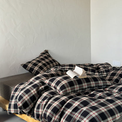 Plaid bedding set on a bed against a plain wall