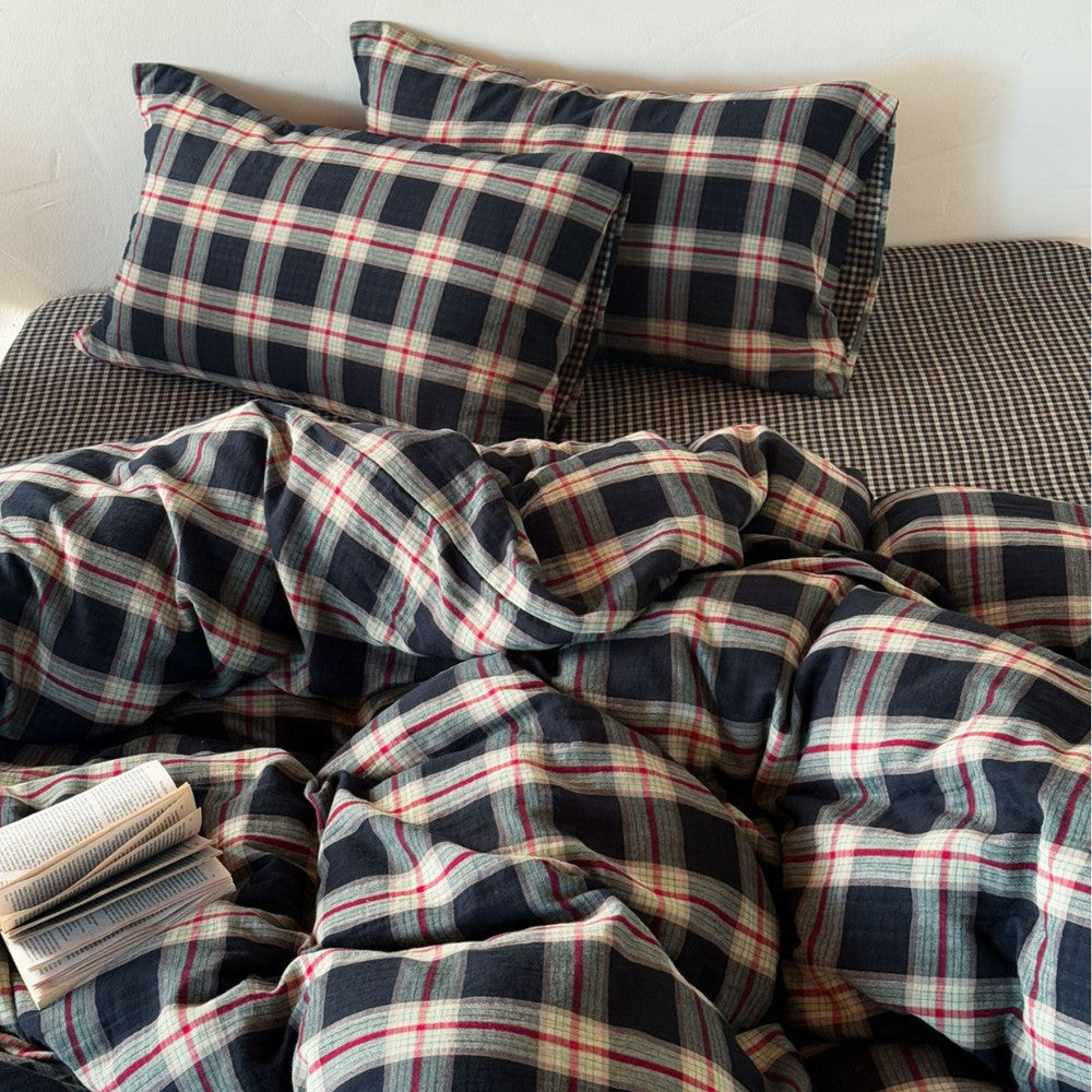 Plaid bedding set with pillows on a bed