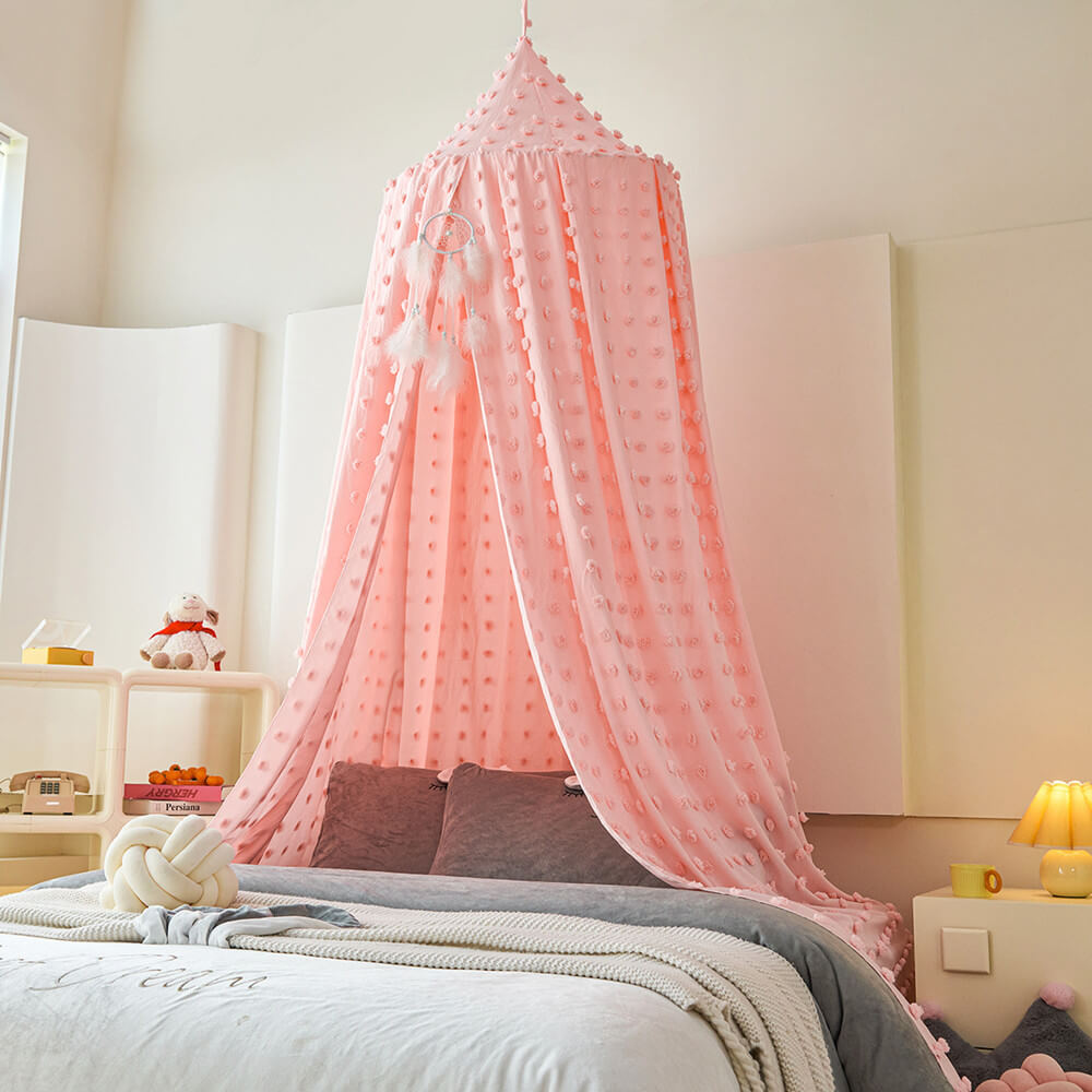 Pink canopy over a bed in a bedroom setting