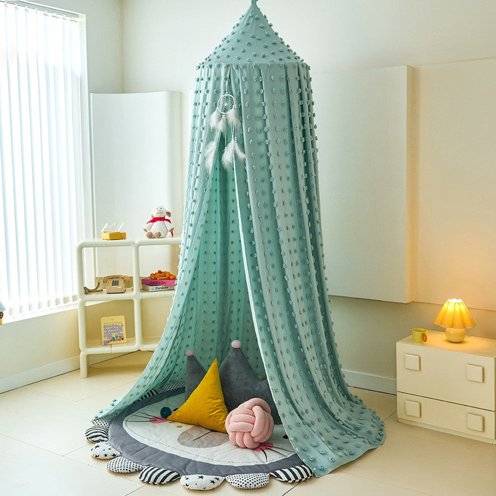 Children's room with a green canopy over a play area, toys, and a small shelf.