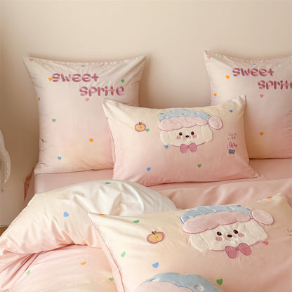 Close-up of blush pink puppy bedding with appliqué dog pillowcases, sweet sprite embroidery, and colorful heart accents