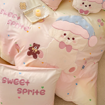 Detail of pastel pink gradient kids bedding with large puppy appliqué, teddy bear embroidery, and sweet sprite lettering