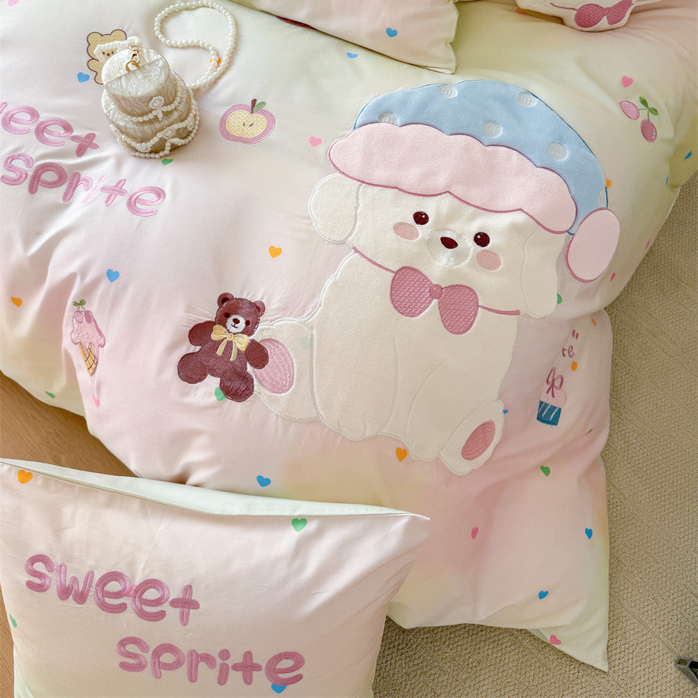 Close-up of pastel mint puppy bedding with appliqué dog embroidery, sweet sprite lettering, and colorful heart details