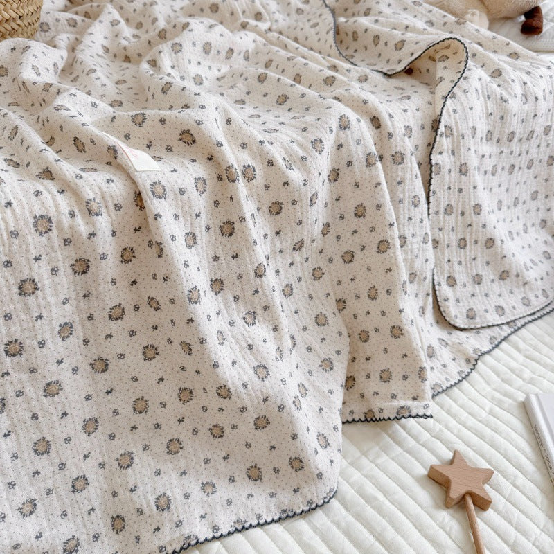 A full view of the pure cotton muslin blanket, showcasing the detailed fennel print and crinkled texture.