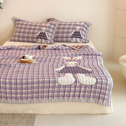 Quilted purple bunny comforter with matching pillowcases and large bunny artwork for kids bedding