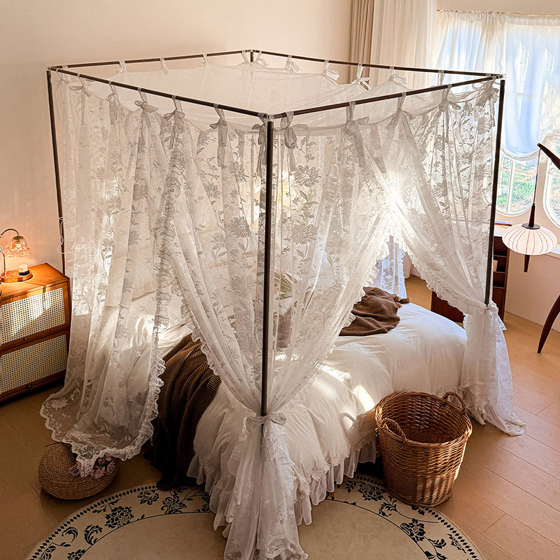 Canopy bed with lace curtains in a bedroom setting