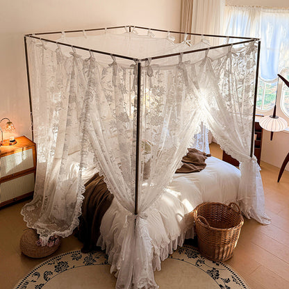 Canopy bed with lace curtains in a bedroom setting