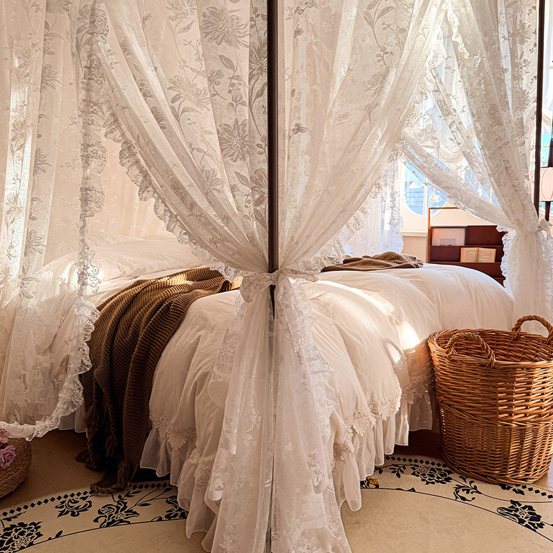 Bed with lace curtains and a wicker basket in a bedroom setting