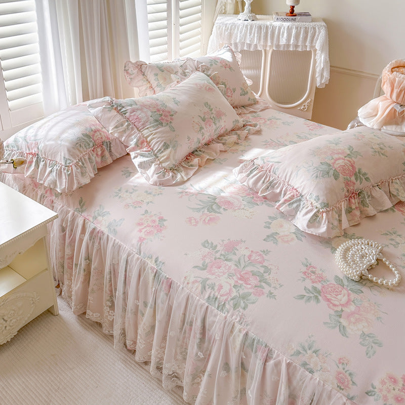 Three-quarter view of the Romantic Garden Bed Skirt in Vintage Blush, featuring pink floral patterns and delicate lace trim.