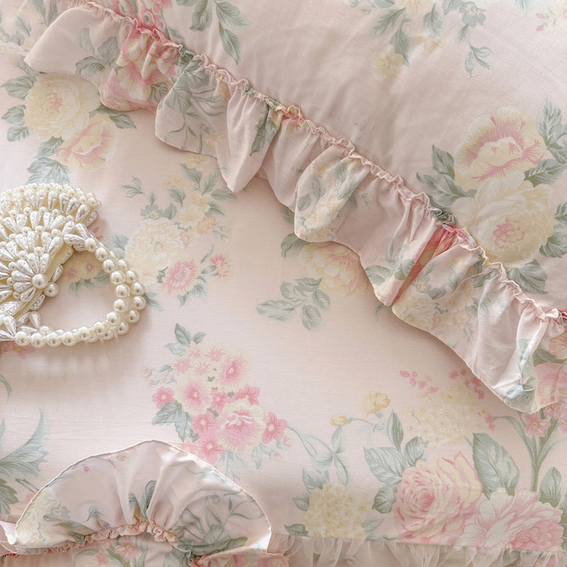 Top-down detail of the Vintage Blush fabric showing the romantic rose print and a pearl-beaded handbag.